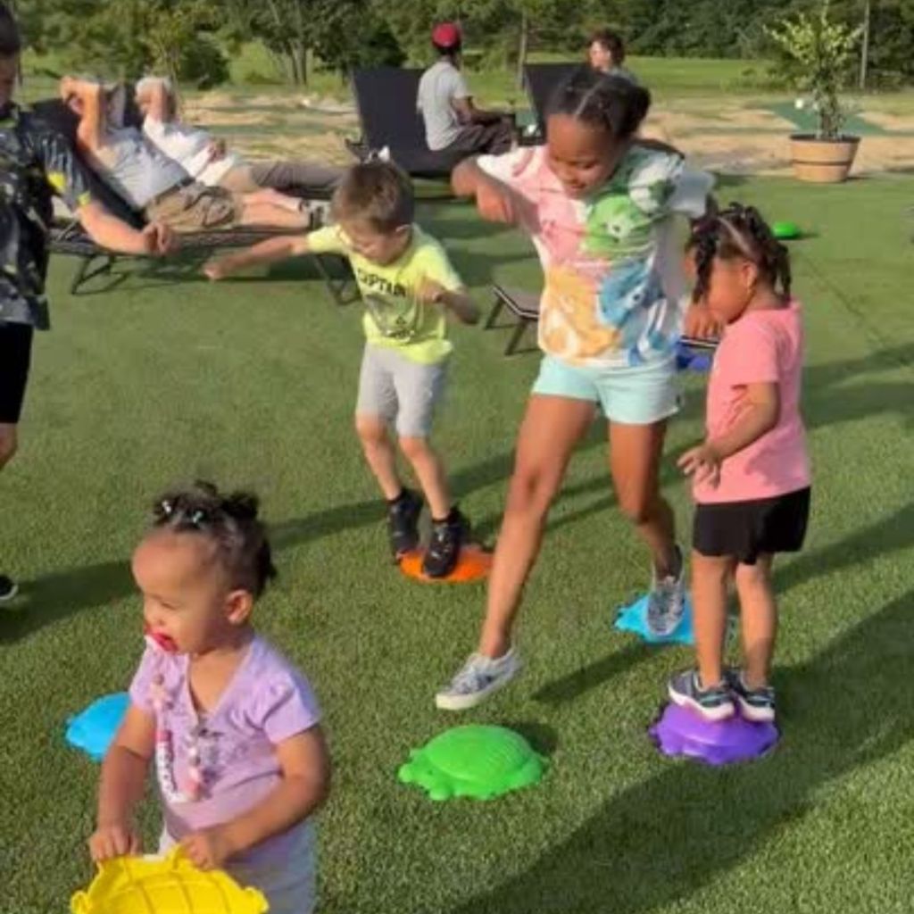 Kids playing on Standing Pines Dance Grass